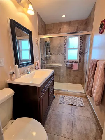 a bathroom with a sink a toilet a mirror and bathtub