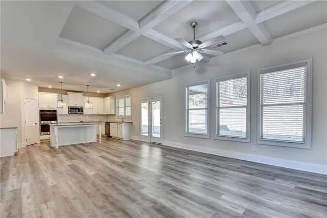 a view of an empty room with a fireplace and a window