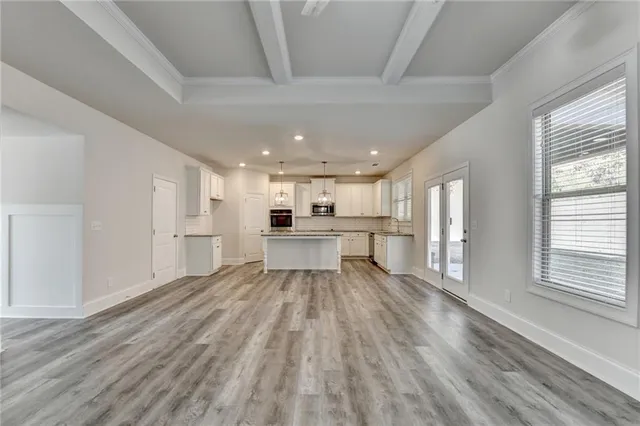 a kitchen with white cabinets appliances and sink