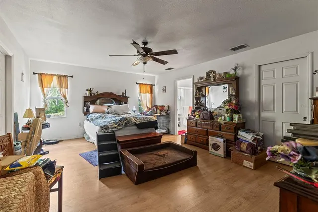 a living room with furniture a chandelier and a window