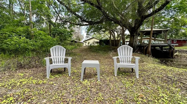 a view of a chairs and fire pit in the patio
