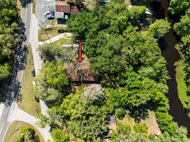 an aerial view of a houses with a yard