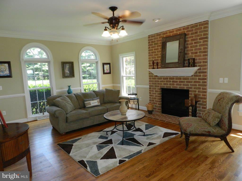 3808 Houcks Road Monkton, MD 21111 - Photo 11 of 30 a living room with furniture a fireplace and a large mirror