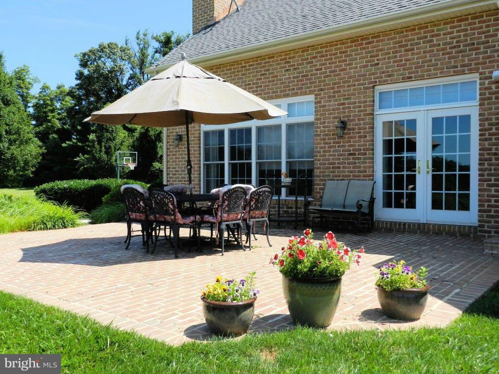 3808 Houcks Road Monkton, MD 21111 - Photo 16 of 30 a view of a house with patio and a garden