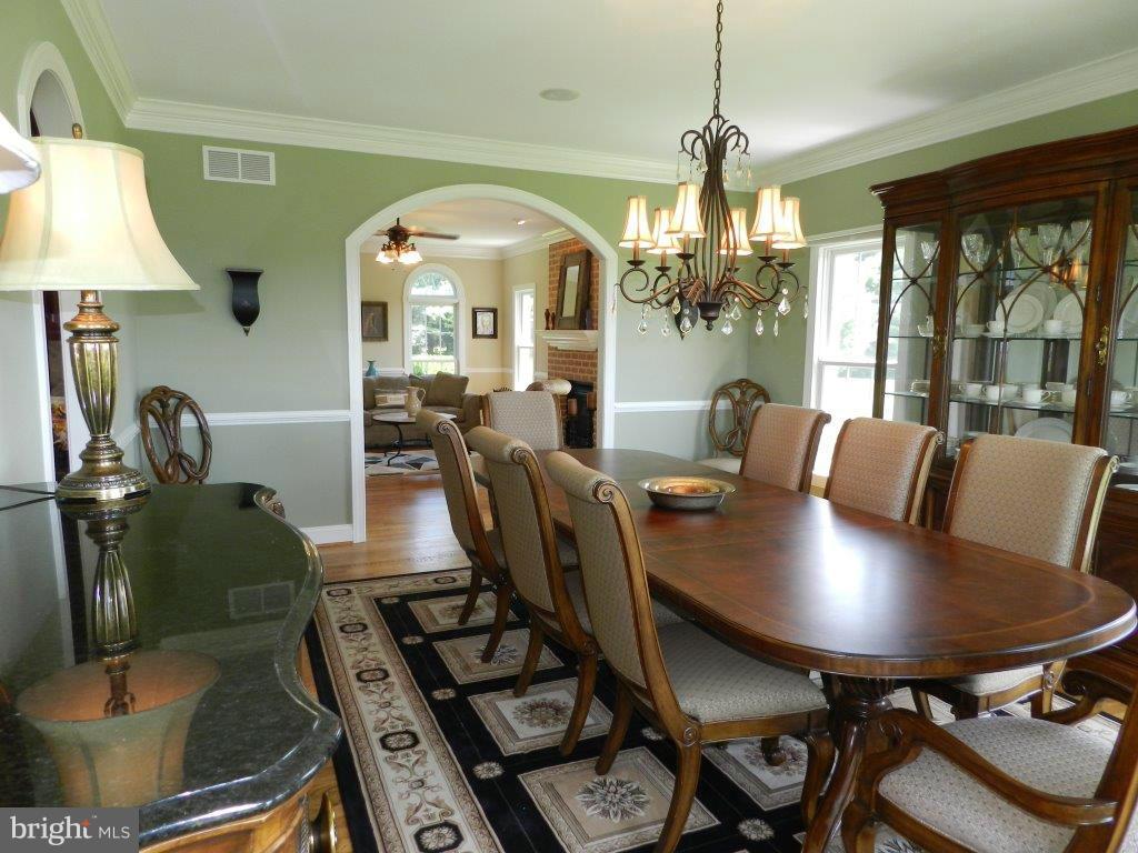 3808 Houcks Road Monkton, MD 21111 - Photo 17 of 30 a view of a dining room with furniture a chandelier and large windows