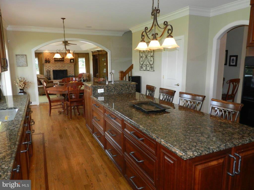 3808 Houcks Road Monkton, MD 21111 - Photo 9 of 30 a kitchen with a table chairs and a chandelier