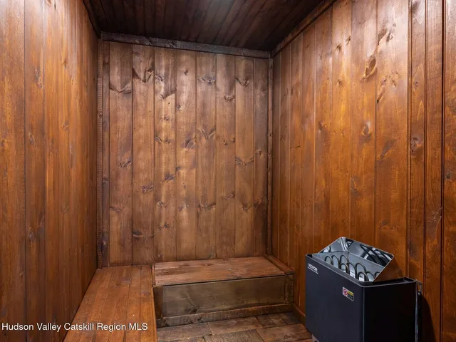 a bathroom with a bathtub shower sink mirror and toilet