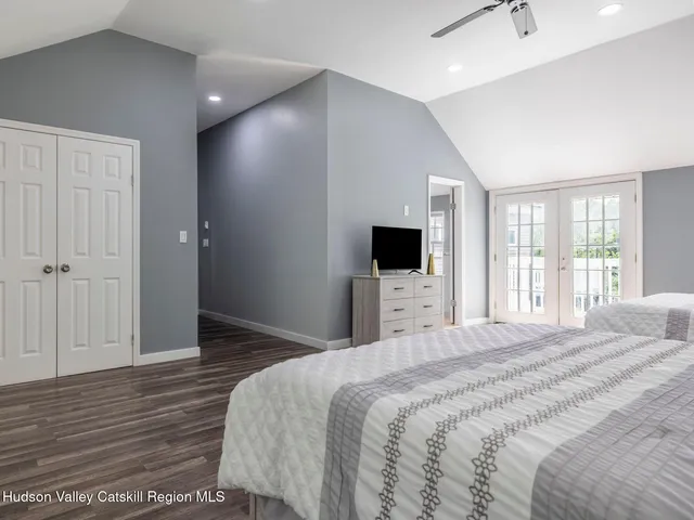 a bedroom with a bed and a flat screen tv