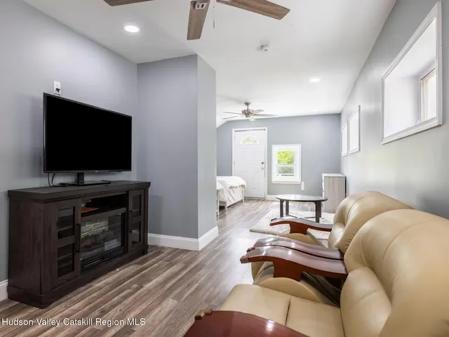 a view of a patio with table and chairs and wooden floor
