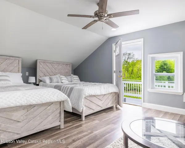 a front view of a house with a garden and yard