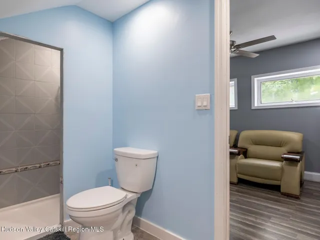 a picture of a room with a white wall and a large window