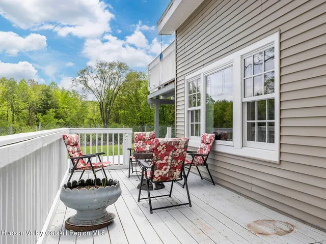 a kitchen with stainless steel appliances white cabinets a sink a stove a refrigerator and a microwave