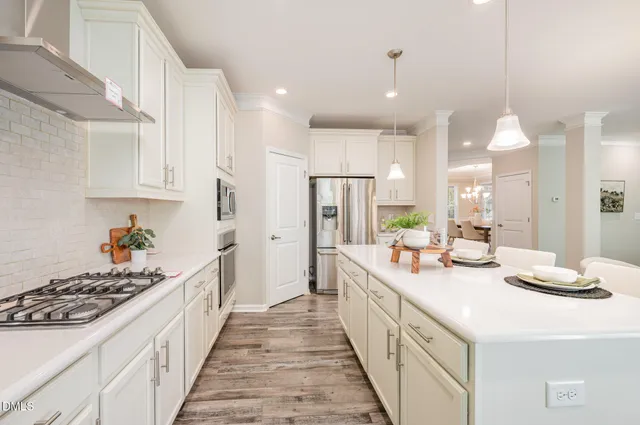 a kitchen with kitchen island a sink appliances and cabinets