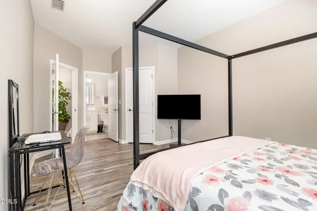 a bedroom with a bed and a night stand