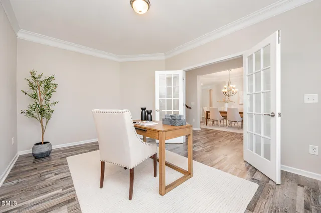 a view of a dining room with furniture and chandelier