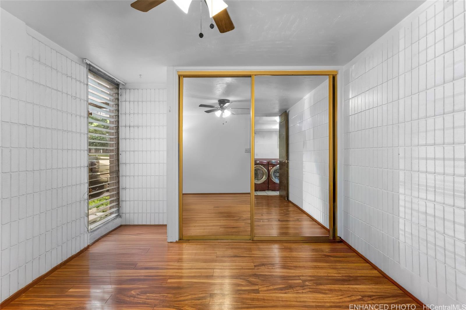 5085 Likini Street, Unit B105 Honolulu, HI 96818 - Photo 9 of 20 a view of a hallway with wooden floor