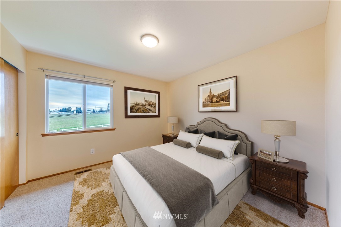 17838 85th Place Northeast Bothell, WA 98011 - Photo 12 of 16 a bedroom with a bed and a painting on the wall