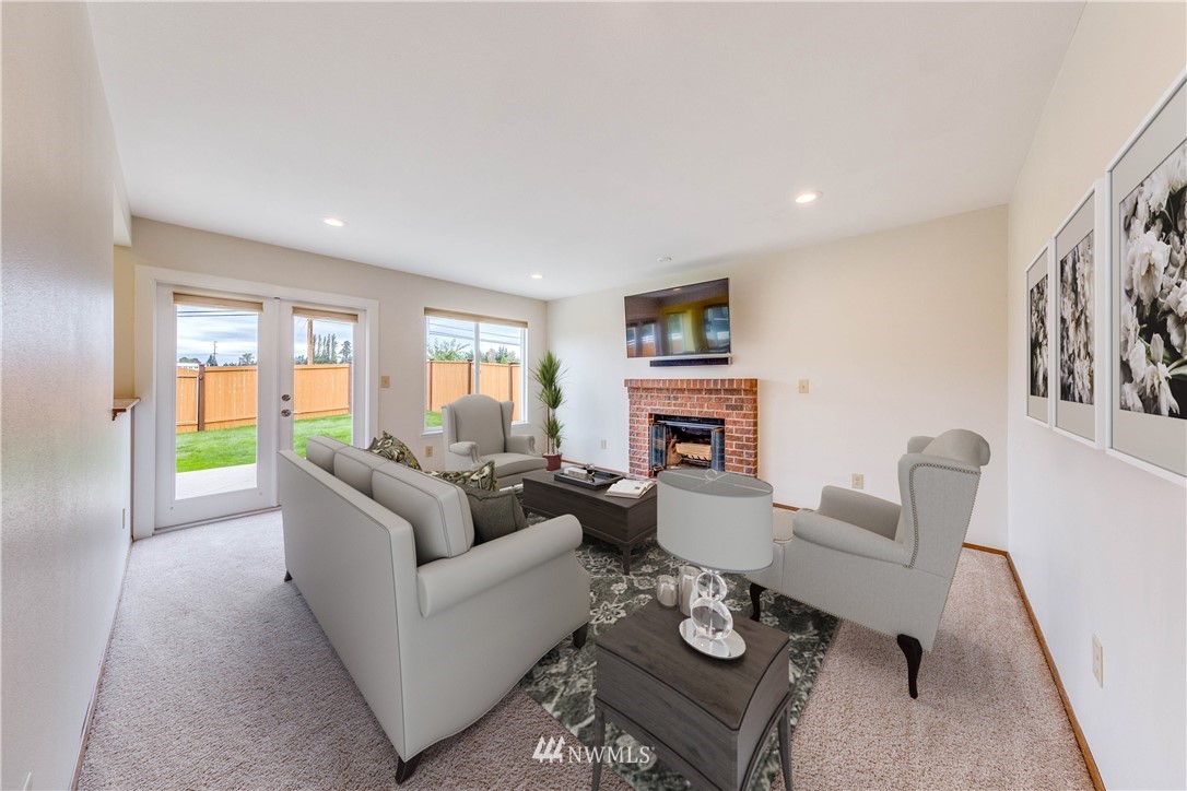17838 85th Place Northeast Bothell, WA 98011 - Photo 6 of 16 a living room with furniture fireplace and a flat screen tv