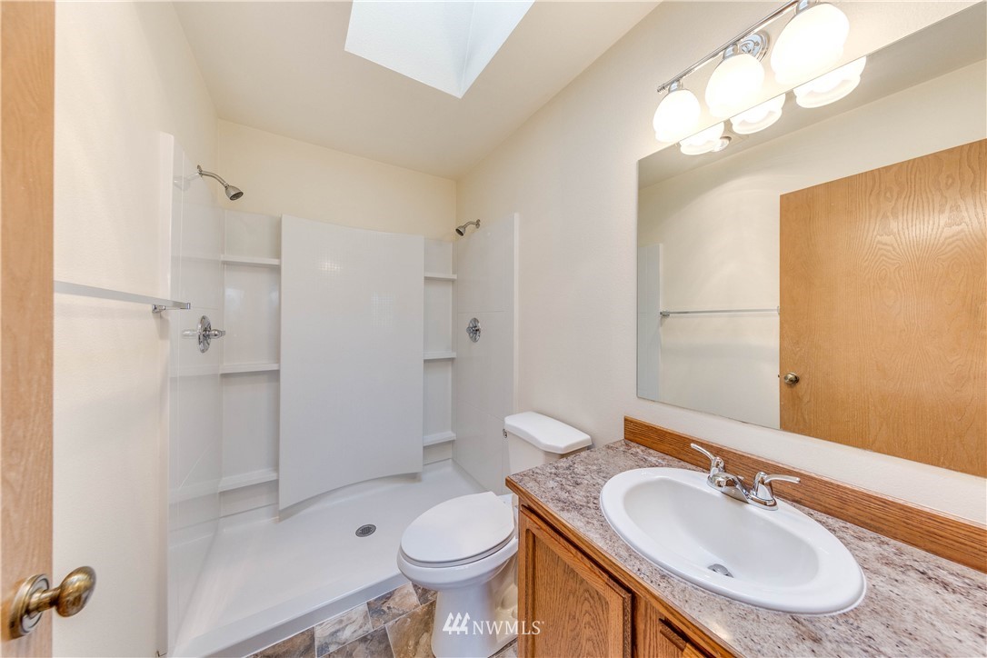 17838 85th Place Northeast Bothell, WA 98011 - Photo 9 of 16 a bathroom with a sink toilet and shower