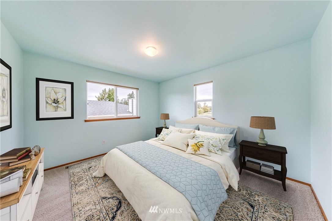 17838 85th Place Northeast Bothell, WA 98011 - Photo 10 of 16 a bedroom with a bed and a lamp on dresser