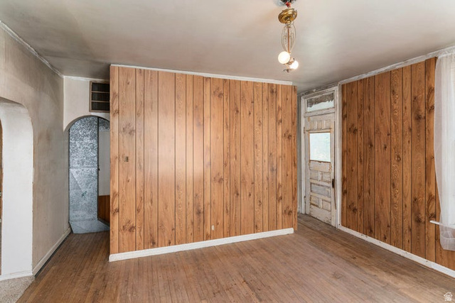 482 West 100 N Street Beaver, UT 84713 - Photo 20 of 41 Unfurnished room with wood-type flooring, arched walkways, and wooden walls