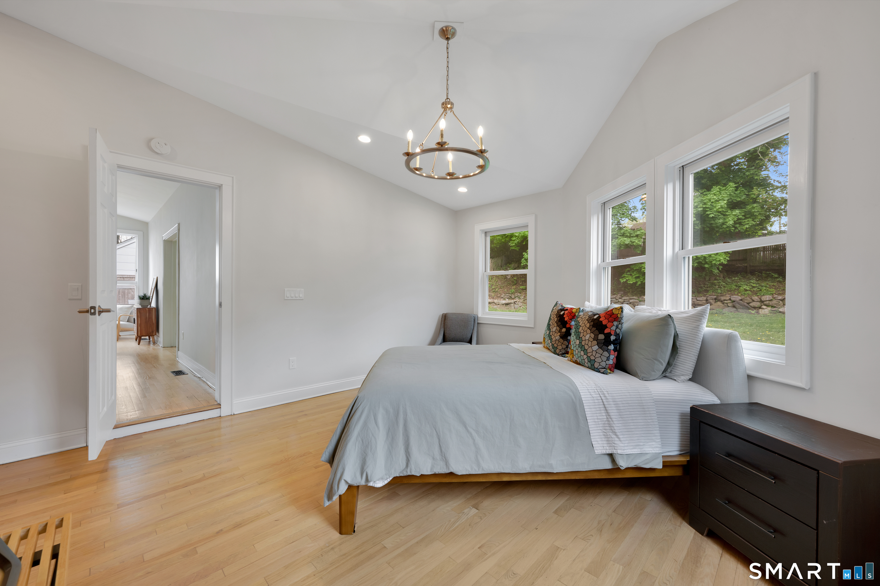20 Lynnbrook Road Fairfield, CT 06825 - Photo 15 of 40 a bedroom with a bed chandelier and a window