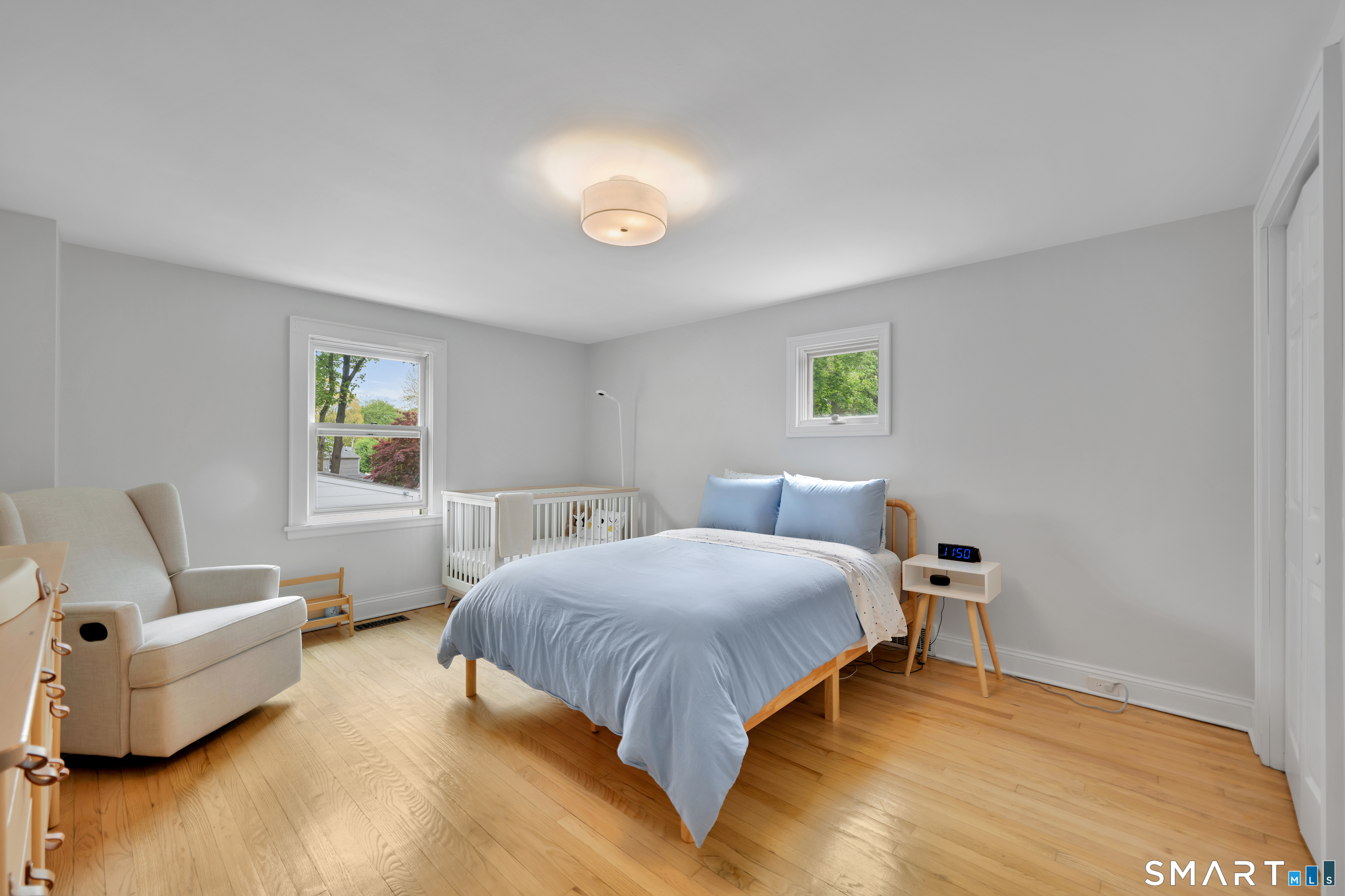 20 Lynnbrook Road Fairfield, CT 06825 - Photo 24 of 40 a bedroom with a bed and wooden floor