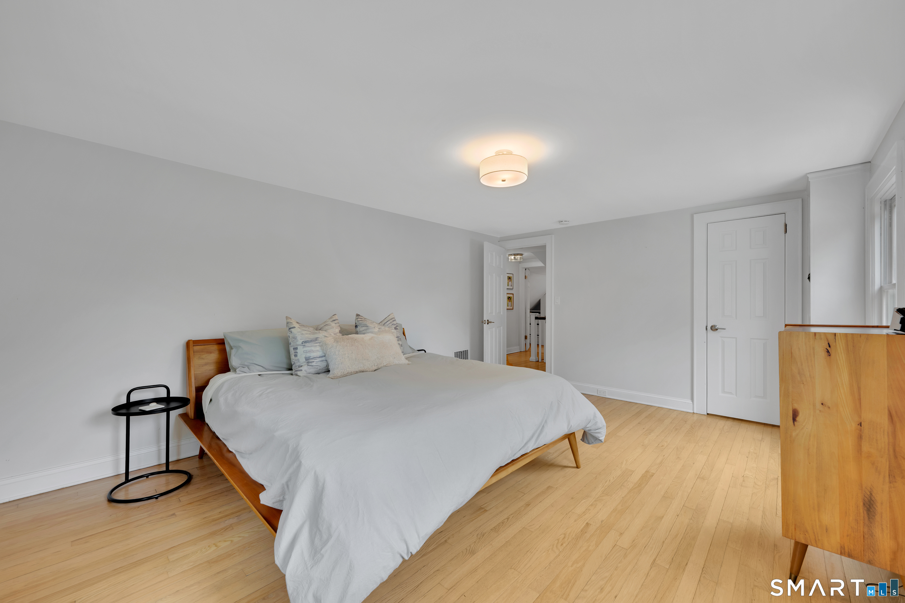 20 Lynnbrook Road Fairfield, CT 06825 - Photo 26 of 40 a bedroom with a bed and wooden floor