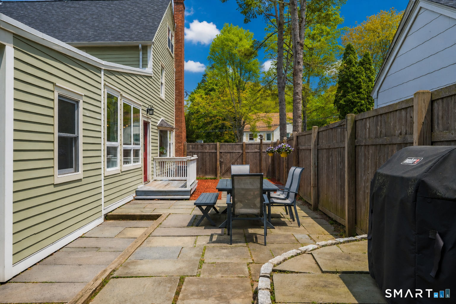 20 Lynnbrook Road Fairfield, CT 06825 - Photo 33 of 40 a view of a patio with table and chairs and wooden fence