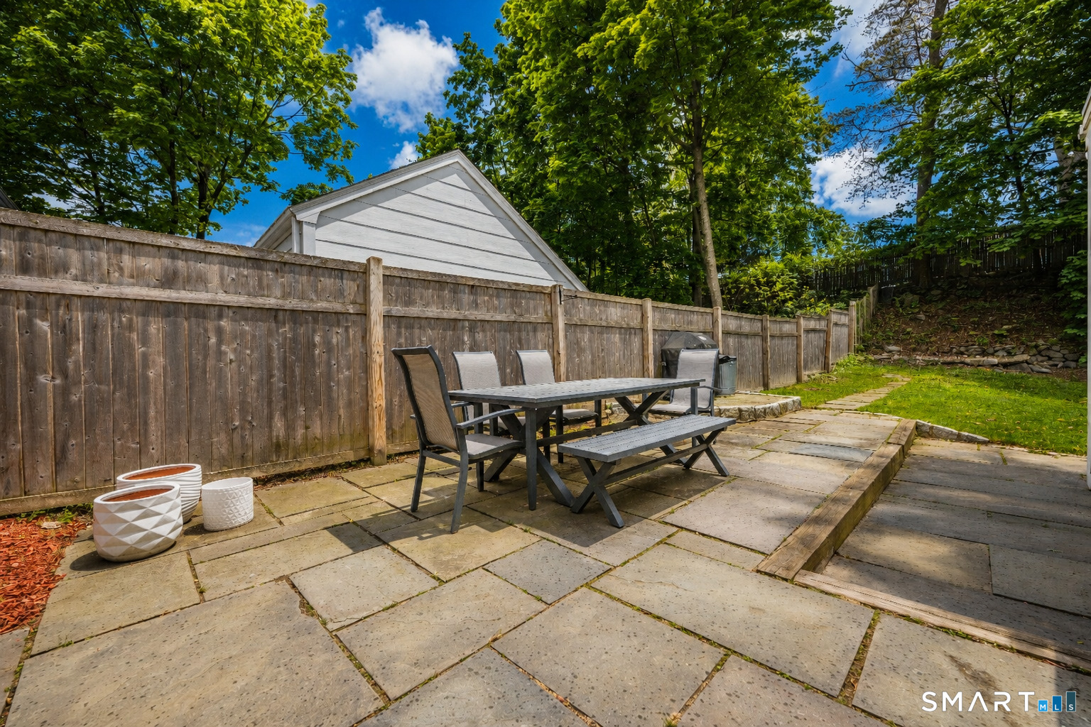 20 Lynnbrook Road Fairfield, CT 06825 - Photo 34 of 40 a view of a patio with a table and chairs
