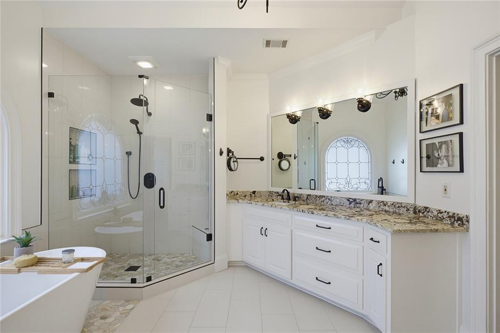 14442 Club Circle Milton, GA 30004 - Photo 36 of 82 a spacious bathroom with a granite countertop tub sink a mirror a vanity and shower