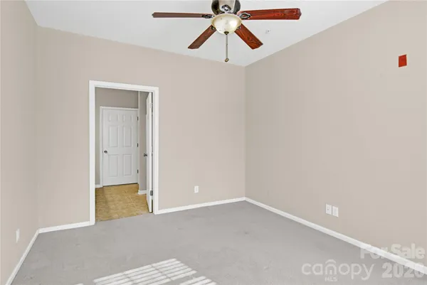 a view of a room with a ceiling fan