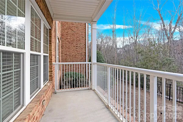 a view of a balcony with a floor and wooden fence