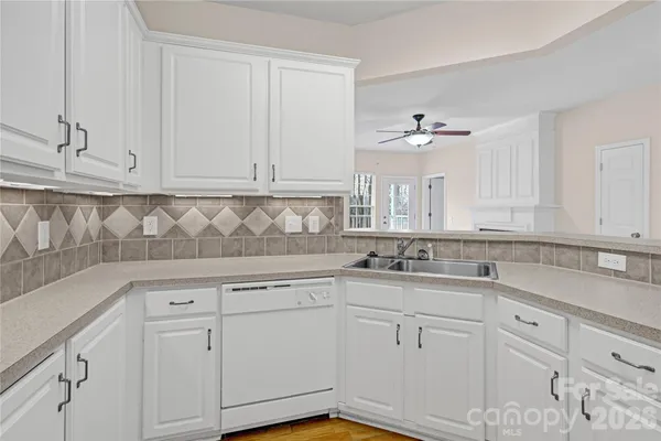 a kitchen with white cabinets and white appliances