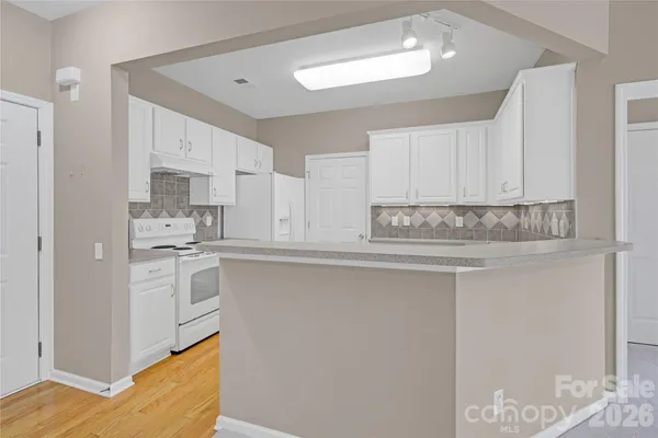 a kitchen with stainless steel appliances granite countertop a sink and cabinets