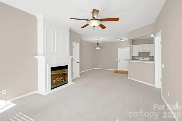 a view of a kitchen with a sink and a fireplace