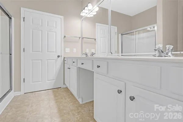 a bathroom with a sink vanity and a mirror
