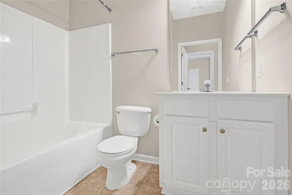 a white toilet sitting next to a bathroom sink