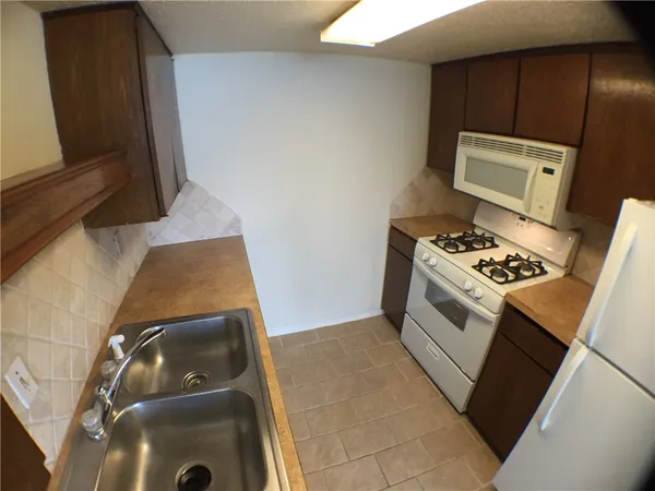 a kitchen with a stove and a microwave