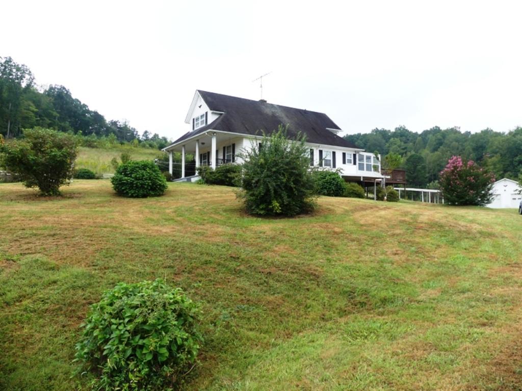 5560 Elamsville Road Stuart, VA 24171 - Photo 2 of 80 a view of a house with a big yard and large trees