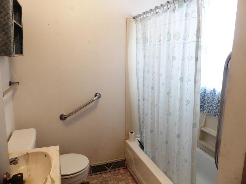5560 Elamsville Road Stuart, VA 24171 - Photo 19 of 80 a bathroom with a toilet a sink and shower curtain