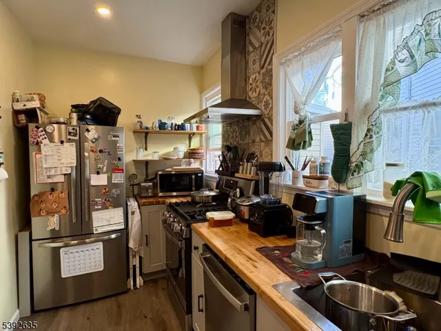 a kitchen with a sink appliances and cabinets