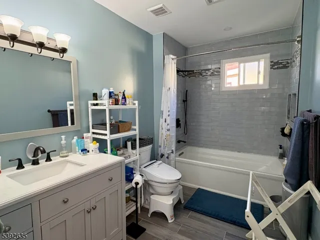 a bathroom with a sink toilet tub and shower
