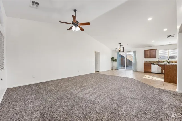 a large kitchen with stainless steel appliances granite countertop a stove granite counter tops and white cabinets