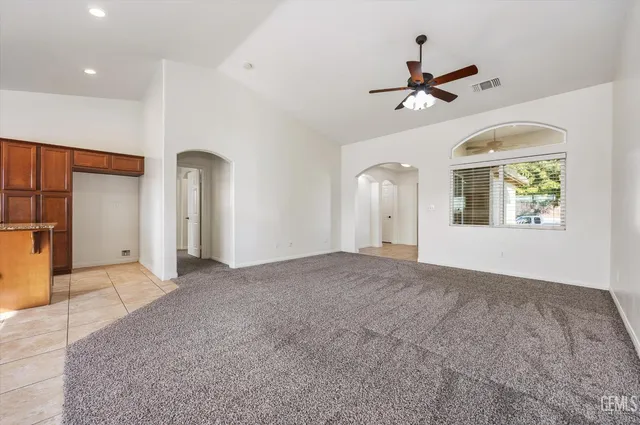 a kitchen with stainless steel appliances granite countertop a sink counter space cabinets and a large window