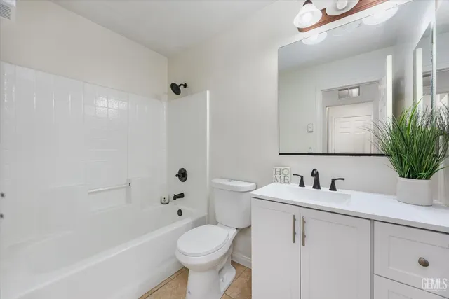 a kitchen with stainless steel appliances kitchen island granite countertop a stove a sink and a microwave