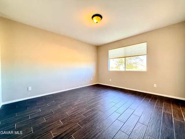 a bathroom with a sink a toilet a mirror and shower