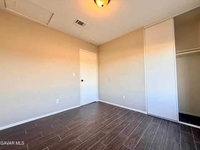a view of a room with wooden floor