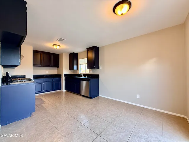 a kitchen with stainless steel appliances granite countertop a sink and cabinets