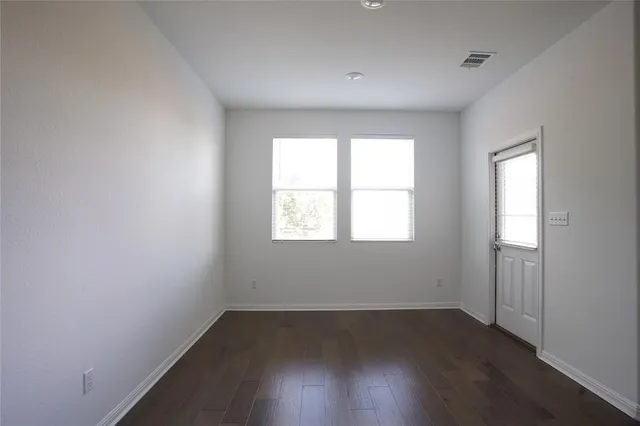 a kitchen with granite countertop a refrigerator and a stove top oven
